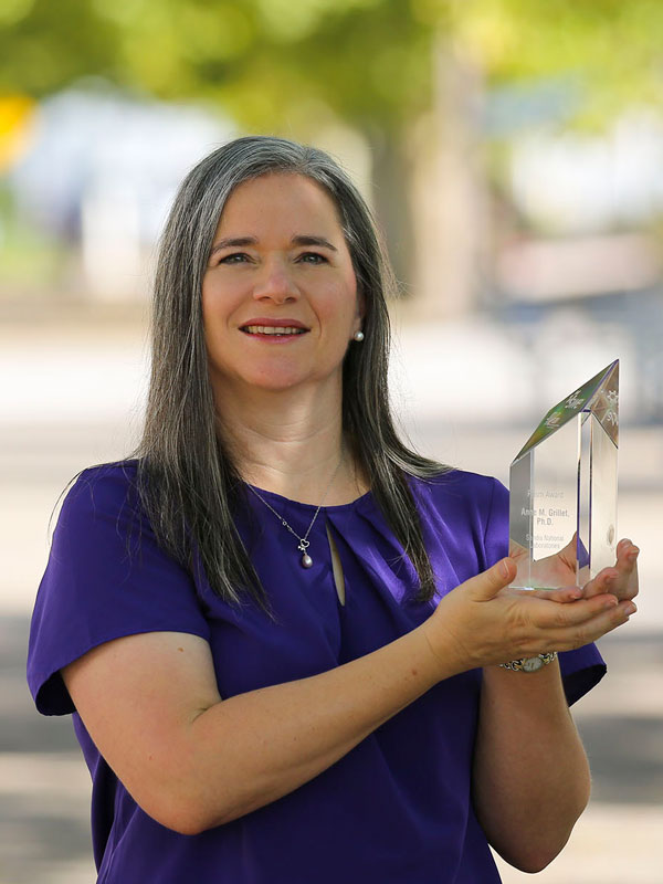 Anne Grillet holding her SWE award