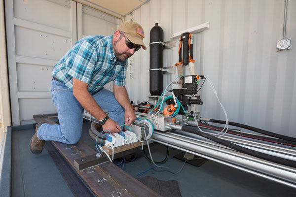 scientist works on SWEPT lab equipment