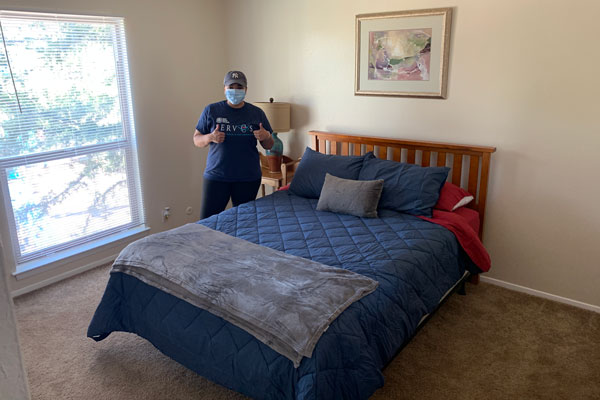 volunteer sets up bedroom