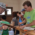 Aaron Hall demonstrates wood working technique