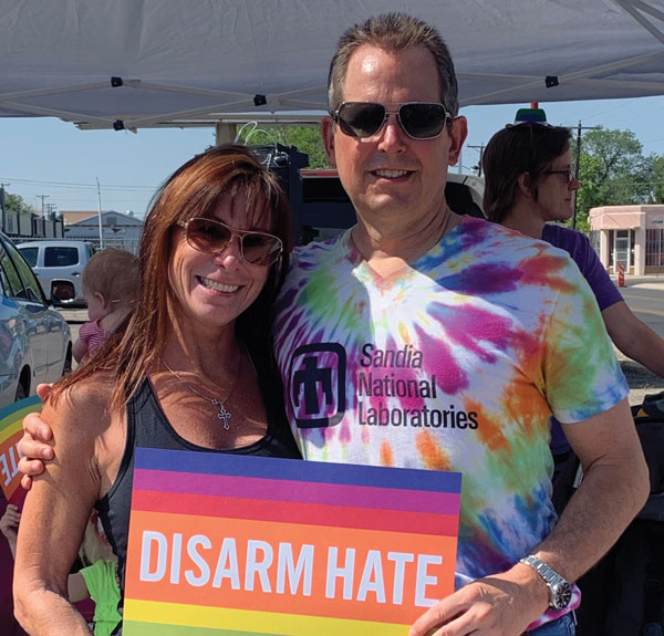 Mark and his wife hold disarm hate sign at PRIDE parade