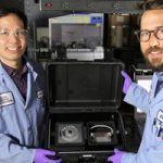 scientists display SpinDx device