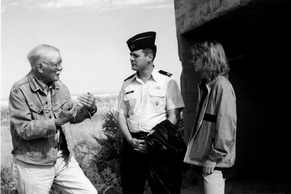 black and white photo of people talking at Trinity site