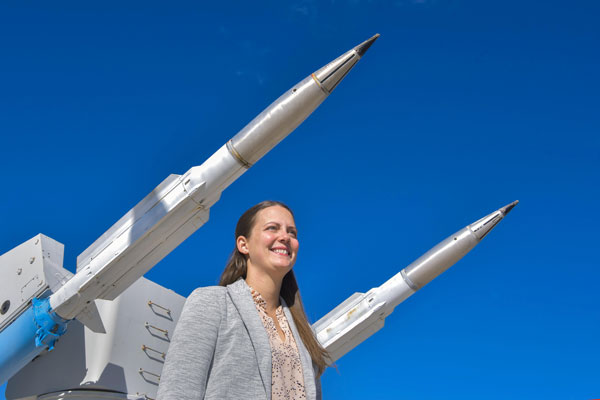 Justine Wolff stands in front of missile display
