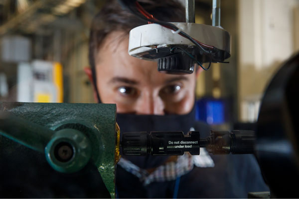 Close-up of researcher working on arc-fault generator