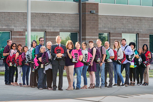 New Mexico volunteers pose with donated backpacks