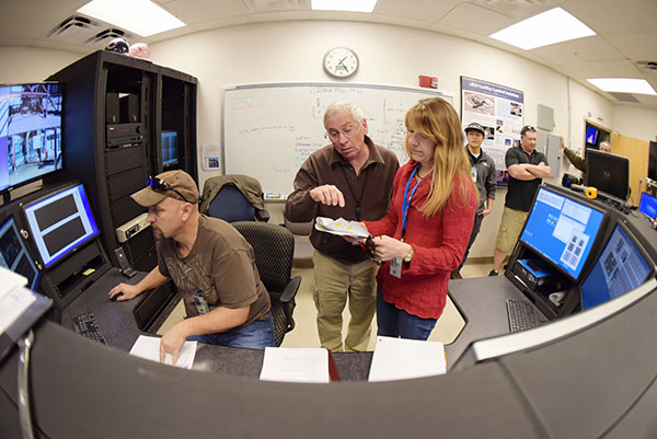 FIRE WATCH — Shane Adee, Tom Blanchat, and Anay Luketa (all 1532) review test procedures in the Thermal Test Complex control room. (Photo by Randy Montoya)