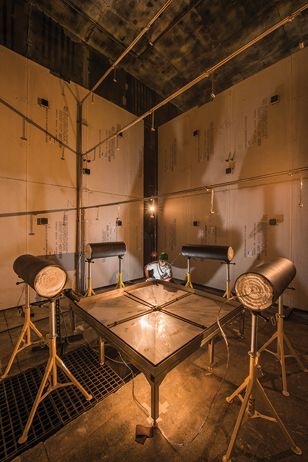 Tom Blanchat prepares for a fuel pan and calorimeter test in the Cross Flow Fire Test Facility, or XTF. (Photo by Randy Montoya)