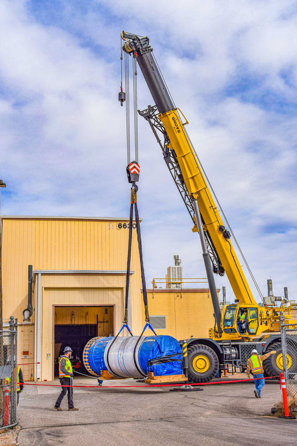 giant steel canister being lifted by crane