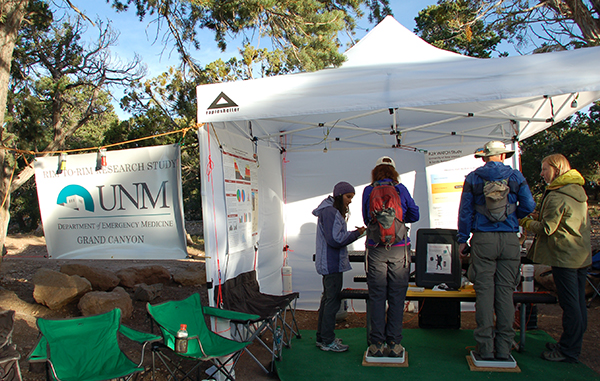 CHECKING IN — Dr. Risa Garcia, (far left) and Dr. Kristin Anchors (far right), from the University of New Mexico Department of Emergency Medicine, collect basic medical data on two rim-to-rim hikers who have volunteered to participate in the R2R WATCH study. (Photo by Patti Koning)