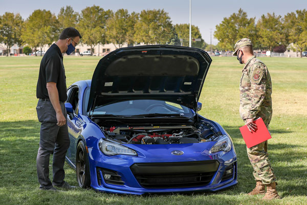 judges inspect car at car show