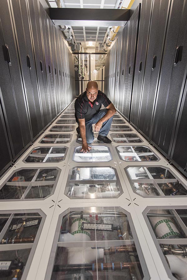 Sandia engineer David J. Martinez examines the cooling system at Sandia’s supercomputing center. Photo by Randy Montoya