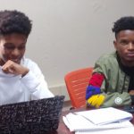 cyber interns work on laptops