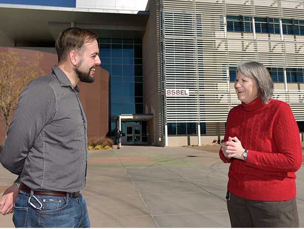 Robin Jacobs-Gedrim chats with Danelle Tanner, the Sandia researcher who inspired him to pursue a career in science when she visited his second grade classroom more than two decades ago. (Photo by Randy Montoya)