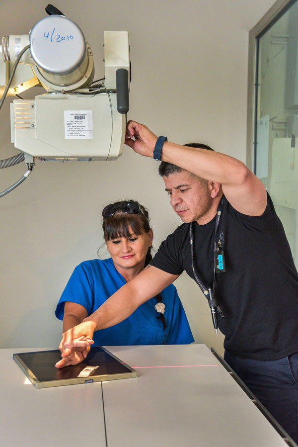 man sets up arm x-ray