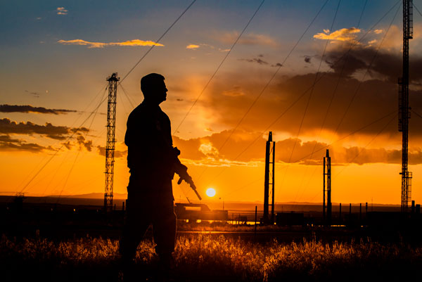 officer silhouetted against sunset 