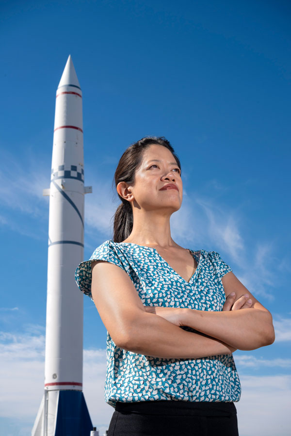 Frances Chance poses with missile in background