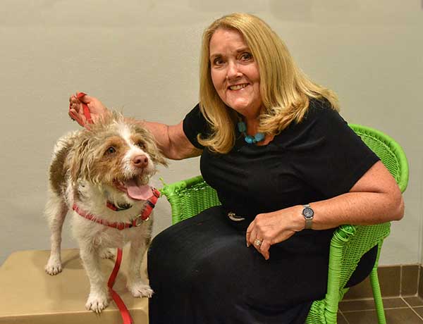 A doggone good idea — Cheryl Atkins visits with a friend at Animal Humane New Mexico. Cheryl says she donates a portion of her ECP contribution each year to nonprofits important to her and always designates a certain portion to go directly to the United Way of Central New Mexico Community Fund. (Photo by Randy Montoya)