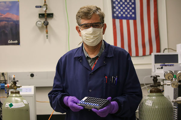 Curtis Mowry with a rack of samples in the lab