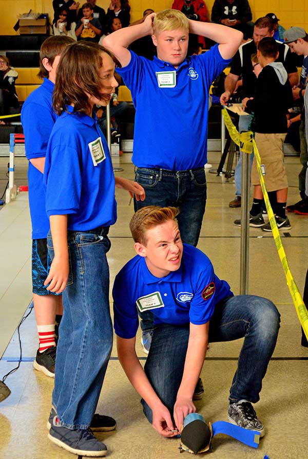 Students check their team standings after racing their electric car.