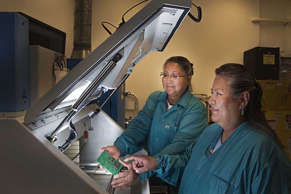 LAB EXPANSION — Maxine Norton, left, and Etta Tsosie (both 5346) work on electronics in a newly expanded section of the Light Electrical Lab. The now-completed upgrade doubled the lab’s floor space, making room for new equipment to take their work to the next level. The lab serves all Sandians. (Photo by Randy Montoya)