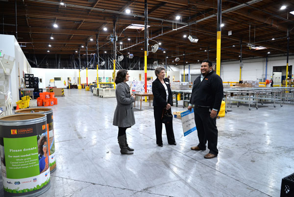 Kayla Norris and Dori Ellis tour food bank with Juan Francisco Orozco