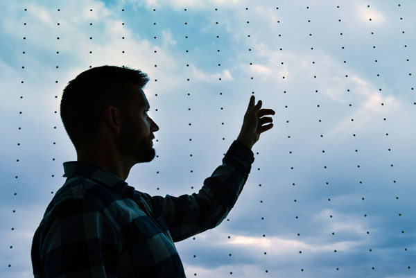 Matthew Baumann points out bird-saving dots on window
