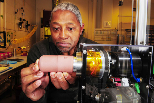 Moses Jones examines equipment in lab