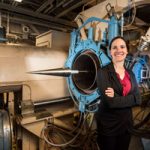 Katya Casper poses in front of wind tunnel