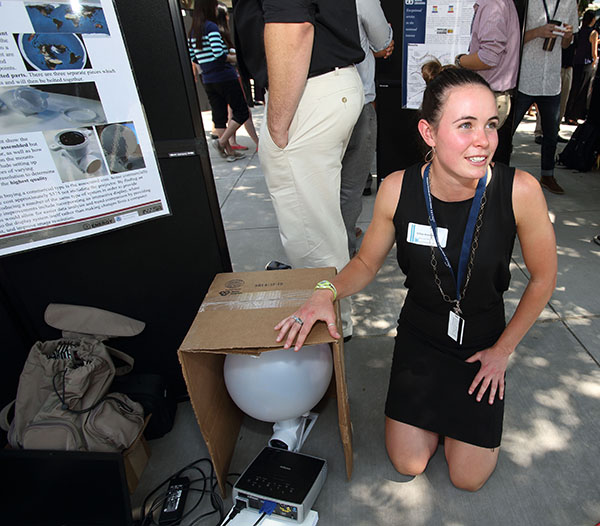 Gillian Krautman (8954) talks to attendees about her summer project.