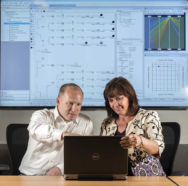 Sandia researchers Nadine Miner and John Eddy are collaborating with the US Marine Corps to help it make smart decisions on renewable energy planning with a powerful software tool called MDT, the Microgrid Design Toolkit.   (Photo by Randy Montoya)