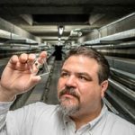 scientist holds up micro sensor