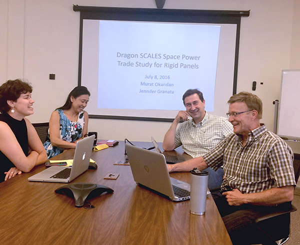 DOWN TO BUSINESS — Murat Okandan, second from right, took advantage of Sandia’s innovative entrepreneurial leave program to try his hand in the private sector, launching mPower, a solar energy business built on Sandia technology. With Murat are, from left, Jennifer Granata, Yun Li, and Pete Atherton discussing mPower’s path forward. (Photo by Neal Singer)