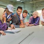 students gather around table to observe nuclear security measures