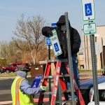 Facilities staff replace accessible parking signs