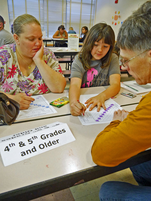 Student getting help from Sandia volunteer