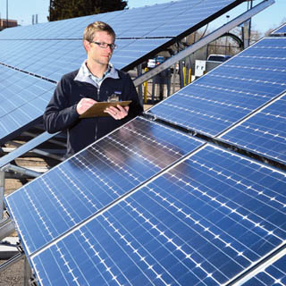 Image of Sandia researcher Geoff Klise worked with Solar Power Electric™ to develop a tool that can be used to appraise photovoltaic installations on homes and businesses. <a href="/news/publications/labnews/archive/_assets/images/12-10-02/pic2lg.jpg">View large image</a>. (Photo by Randy Montoya)