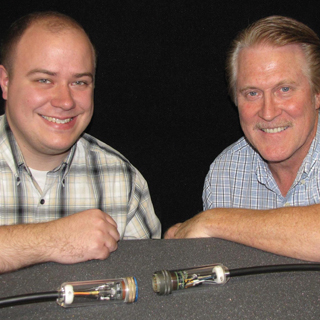 CABLE GUYS Ñ Titus Appel and Steve Sanderson (both 6623) with a first-generation power-over-fiber cable that converts a signal from electrical-to-optical-to-electrical, thus emulating an electrical cable with total isolation.