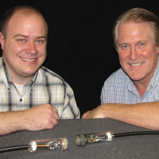 CABLE GUYS — Titus Appel and Steve Sanderson (both 6623) with a first-generation power-over-fiber cable that converts a signal from electrical-to-optical-to-electrical, thus emulating an electrical cable with total isolation.