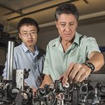 Former Sandia researcher Yuanmu Yang, left, and Sandia’s Igal Brener set up to do testing in an optical lab.