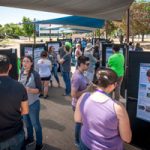 interns talk about their projects with visitors during the event