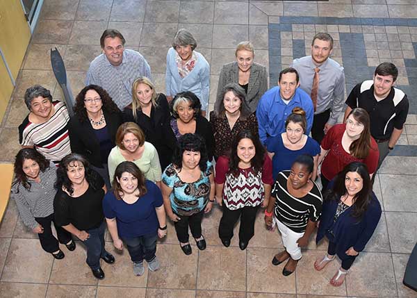 Members of the Accounting Services and Payroll Services teams gather in the lobby of the IPOC building for a family portrait. The two teams were recognized at the annual Quality New Mexico Learning Summit and Performance Excellence Awards ceremony with Piñon-level awards for strides they have made on their quality journeys.	(Photo by Randy Montoya)