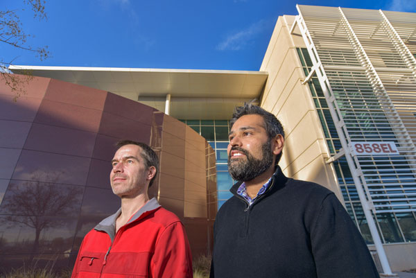 Peter Maunz and Ojas Parekh standing in front of Sandia facility