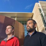 Peter Maunz and Ojas Parekh standing in front of Sandia facility