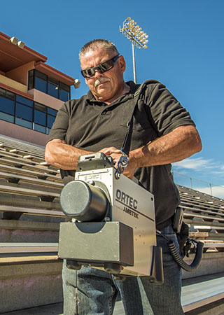 RAP team member Gary Baldonado prepares to scan an arena before a game.  (Photo by Randy Montoya)