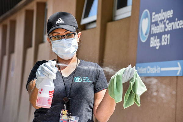 custodian sprays disinfectant
