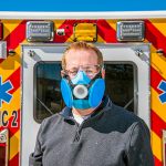 Engineer Todd Barrick models a prototype of reusable N95 respirator