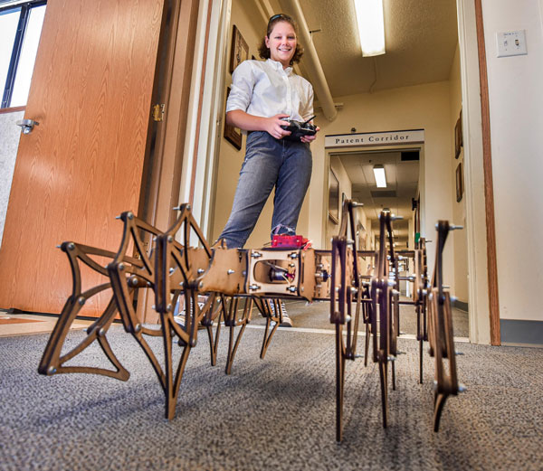 student drives remote control robot spider