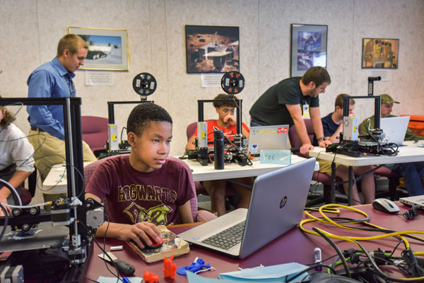 students and volunteers work together in computer lab