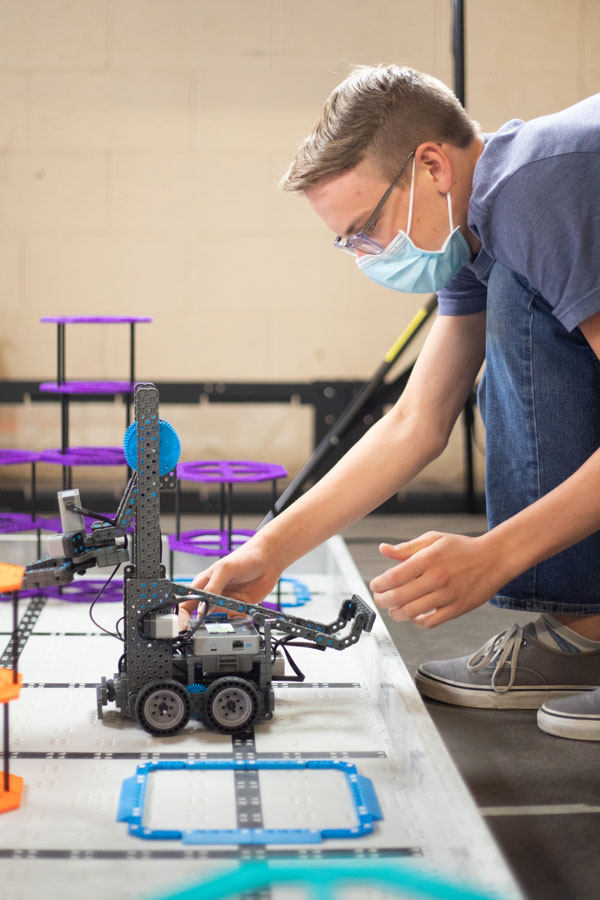 kid works on robot